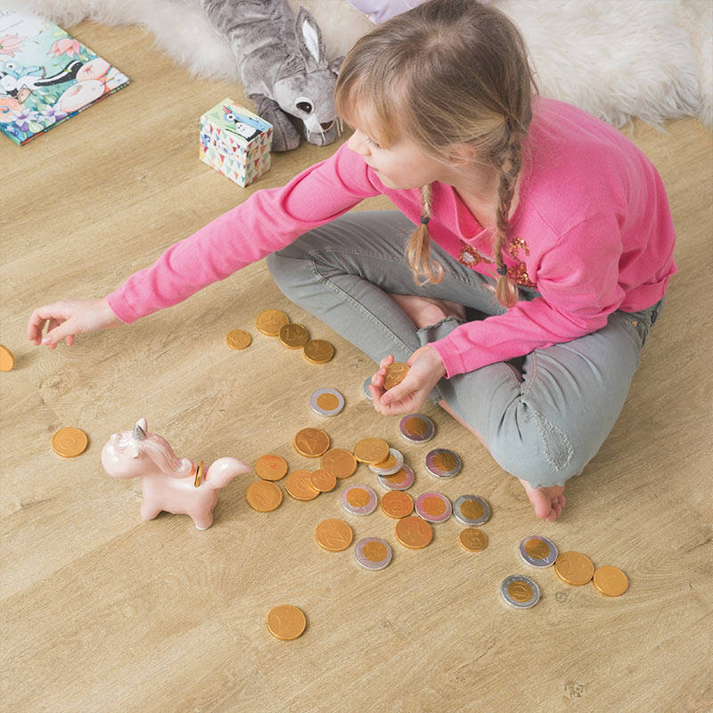 girl playing with coins on eligna quick step venice oak natural laminate floor