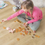 girl playing with coins on eligna quick step venice oak natural laminate floor