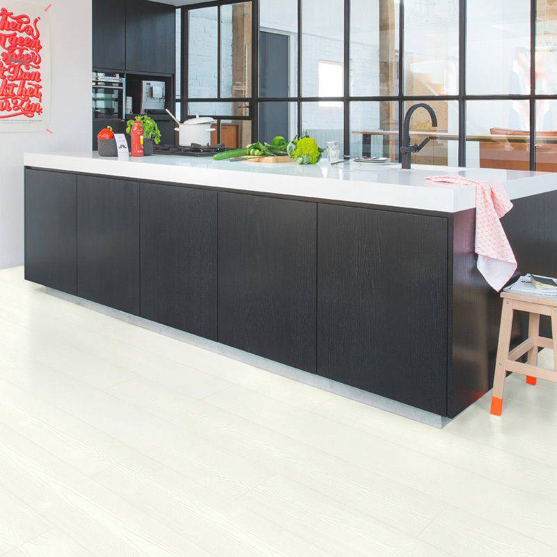 quick step white wood laminate plank flooring in a kitchen