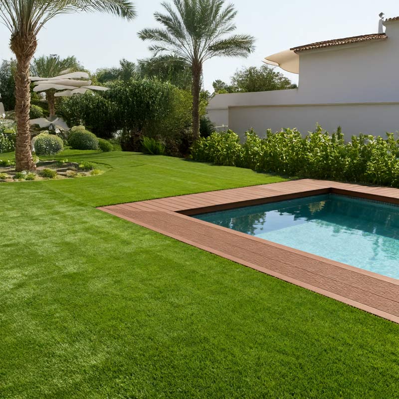 seneca artificial grass turf in villa back garden with pool and palm tree