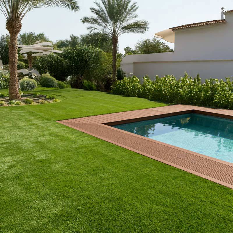 seneca artificial grass turf in villa back garden with pool and palm tree