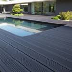 slate grey smart decking in garden with pool and shrubs