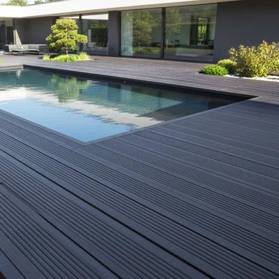 slate grey smart decking in garden with pool and shrubs