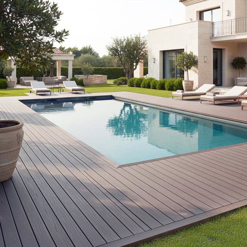 chocolate brown smart decking next to pool and lounge set in garden