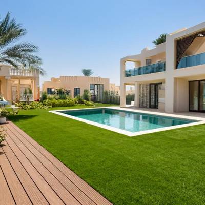 bahia artificial grass turf surrounding pool in villa garden