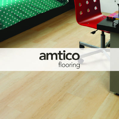 amtico flooring logo imposed over studio bedroom with wooden floor, desk, and bed