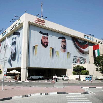 dewa head office building with cars and people walking out front