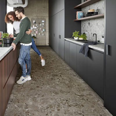 berry alloc pure tiles terrazzo dark grey vinyl click tiles in kitchen with couple