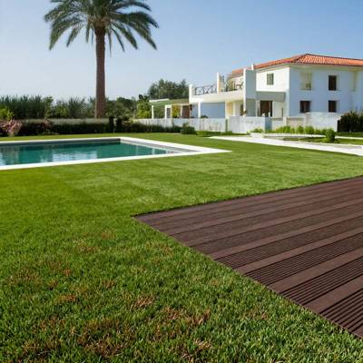 redwood 40 artificial grass in villa back garden with pool and decking and palm tree