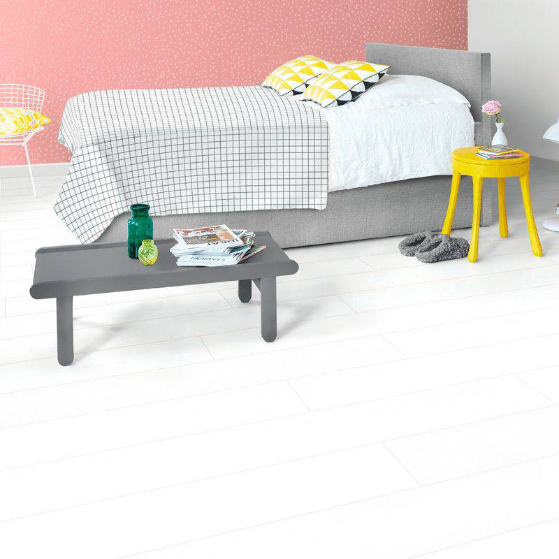 quick step white wood laminate plank flooring in a bedroom