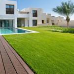 seneca artificial grass turf in villa back garden with pool and decking