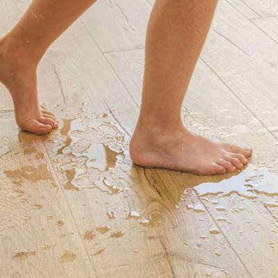 wet person walking across classic oak laminate beige floor