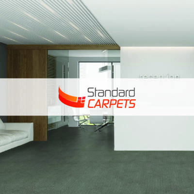 light red standard carpets logo imposed over living studio with ash grey carpet