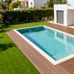 redwood 30 artificial grass in villa back garden next to pool and decking