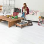 quick step white wood laminate plank flooring in a living room