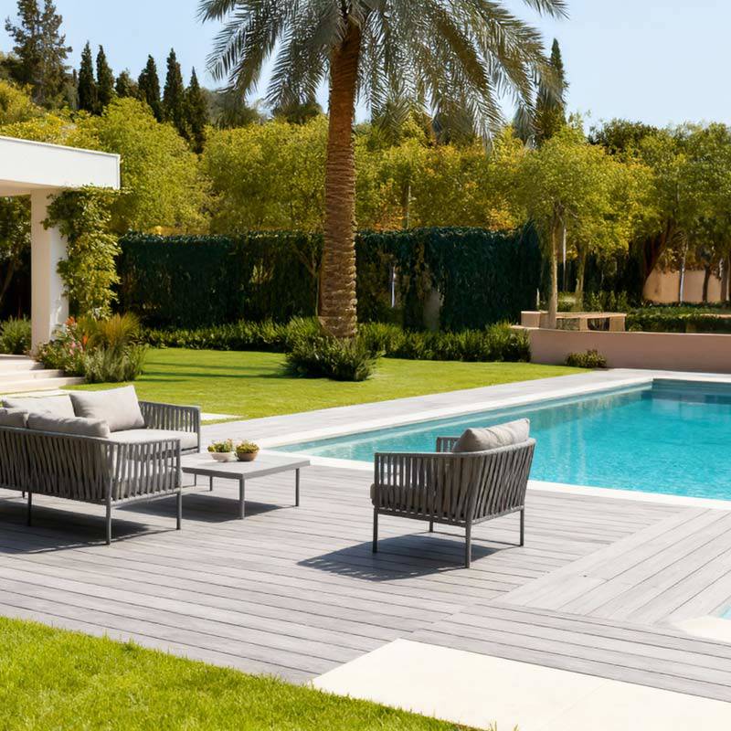 grey smart decking in villa back garden with pool and dining set