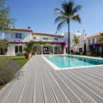 warm grey smart decking in villa garden with pool