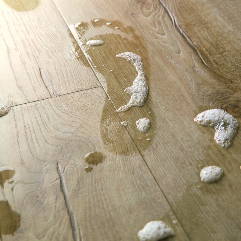 person's wet footprint on classic oak beige floor
