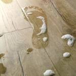 person's wet footprint on classic oak beige floor