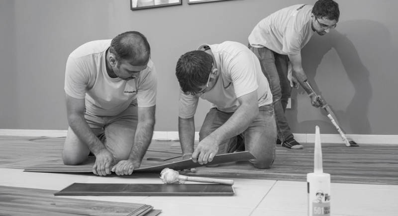 floorworld team members installing a wooden floor