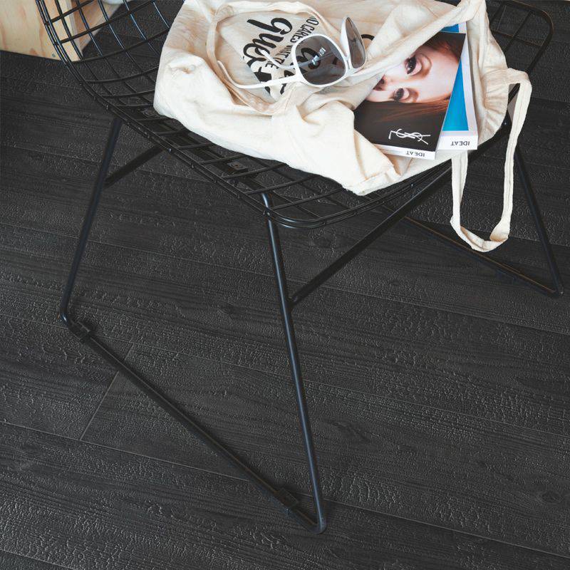 burned wooden plank laminate flooring in bedroom sitting space